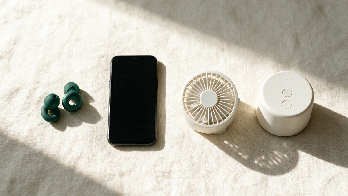 Earplugs, a phone, a small fan and a one-button sound machine in a row. The first three are crossed out.